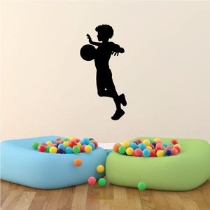 Black soccer player vinyl wall decal with kicking pose silhouette