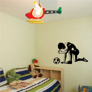 Soccer wall decal showing player kicking a soccer ball