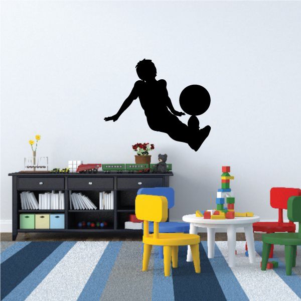 Black soccer wall decal of a player kicking a ball
