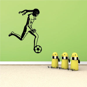 Soccer player wall decal of a running figure kicking a soccer ball