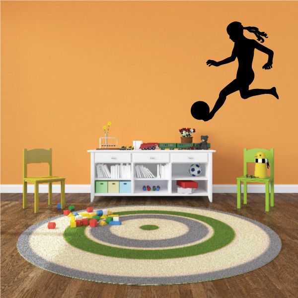 Soccer wall decal, black player kicking soccer ball silhouette.