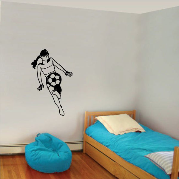 Soccer wall decal of a black soccer player dribbling a ball