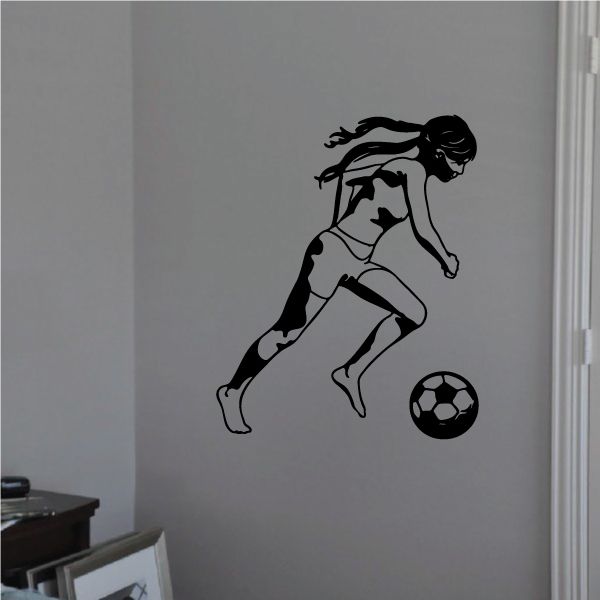 Soccer wall decal of a black player kicking a soccer ball, vinyl graphic