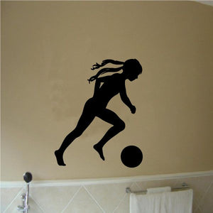 Soccer wall decal of a black player kicking a soccer ball