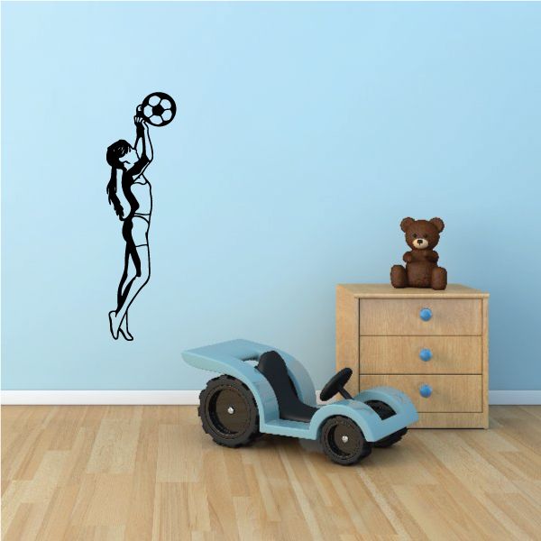 Soccer wall decal of a black silhouette player with a soccer ball overhead