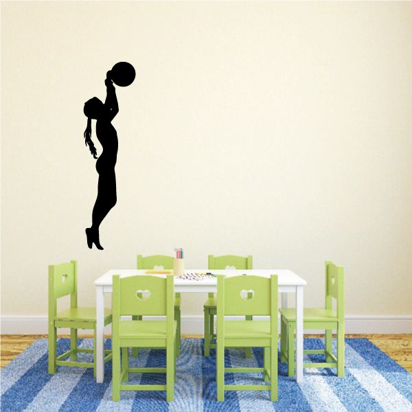 Black soccer player wall decal silhouette with ball overhead.