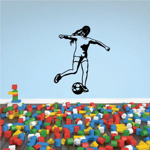 Soccer player wall decal with black vinyl silhouette kicking a soccer ball