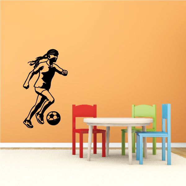 Soccer wall decal vinyl: black soccer player kicking a ball.