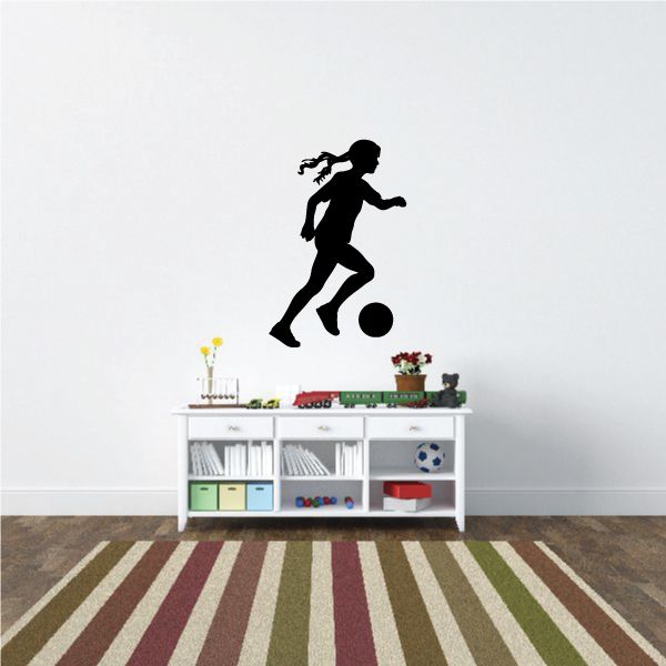 Black soccer player wall decal with small soccer ball silhouette