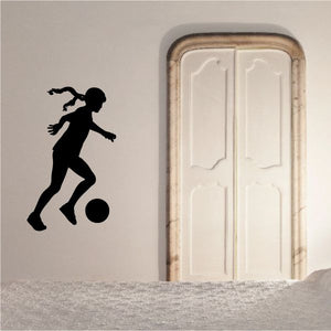 Soccer player wall decal with black silhouette kicking a ball