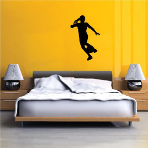 Soccer wall decal vinyl of a black player silhouette in mid-kick