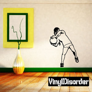 Soccer wall vinyl decal of a goalie holding a ball, black outline