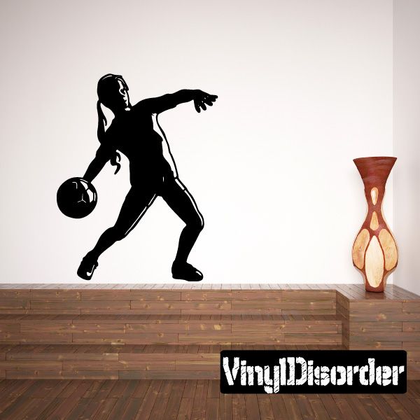 Vinyl soccer wall decal of a player dribbling a ball, black silhouette
