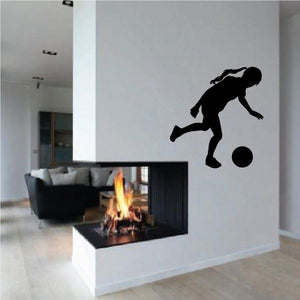Soccer wall decal vinyl featuring a black soccer player kicking a ball silhouette