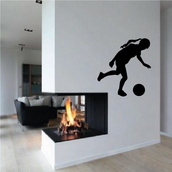 Soccer wall decal vinyl featuring a black soccer player kicking a ball silhouette