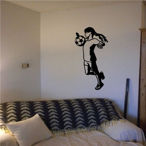 Soccer player wall decal vinyl sticker, black silhouette holding a soccer ball