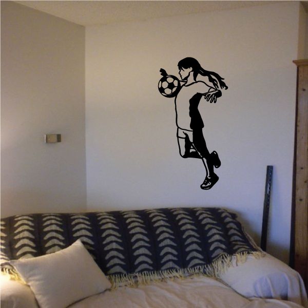 Soccer player wall decal vinyl sticker, black silhouette holding a soccer ball