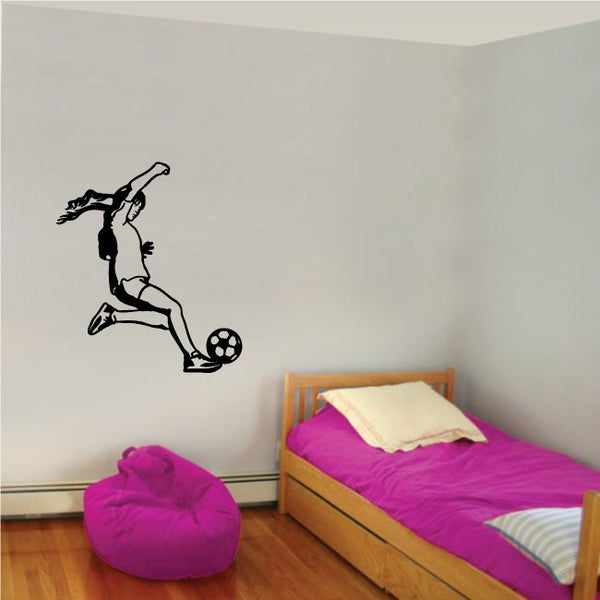 Soccer wall decal of a black player kicking a soccer ball