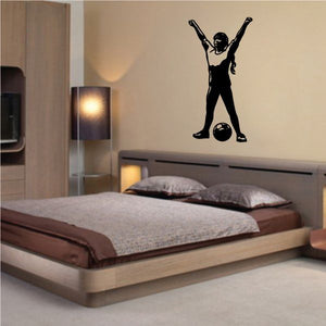 Soccer player wall decal in black vinyl, arms raised over a ball