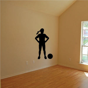 Soccer player wall decal, black silhouette of a female athlete standing with soccer ball