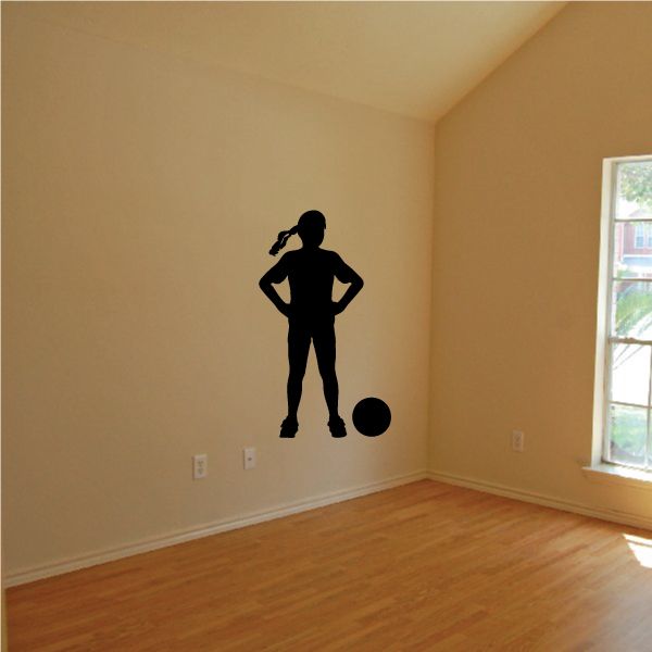 Soccer player wall decal, black silhouette of a female athlete standing with soccer ball