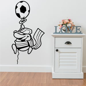 Soccer wall decal of black vinyl soccer player holding a ball