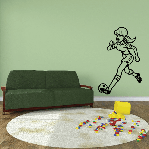 Soccer wall decal of a cartoon girl kicking a soccer ball with flowing hair
