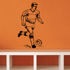 Soccer player vinyl wall decal: dark running with soccer ball