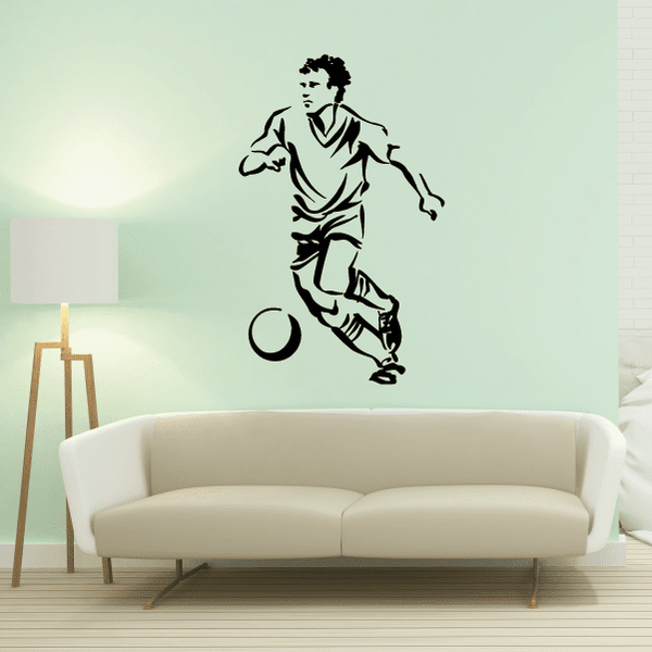 Black soccer player wall vinyl decal, mid-kick with ball