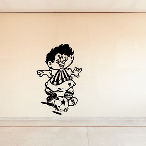 Soccer wall vinyl decal of cartoon player kicking a soccer ball