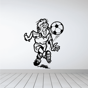 Soccer wall decal of cartoon player kicking a soccer ball, vinyl sticker