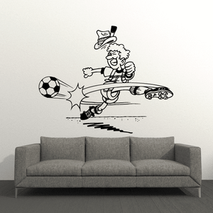 Soccer wall vinyl decal of a cartoon player dribbling and kicking a soccer ball