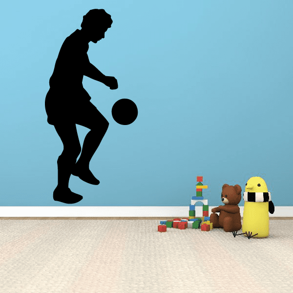 Soccer player wall decal with black silhouette kicking a soccer ball