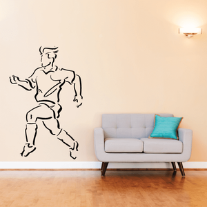 Soccer wall vinyl decal of black-outlined soccer player kicking ball