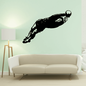 Soccer wall decal of a black soccer player in mid-kick