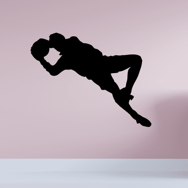 Soccer player wall decal, black vinyl silhouette jumping with ball