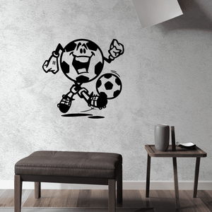 Soccer wall decal with black soccer player holding a ball and kicking a boot