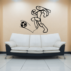 Soccer wall vinyl decal of black player kicking a soccer ball and trail lines