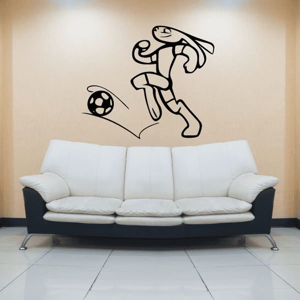 Soccer wall vinyl decal of black player kicking a soccer ball and trail lines
