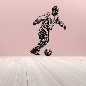 Soccer wall decal of a running player kicking a soccer ball