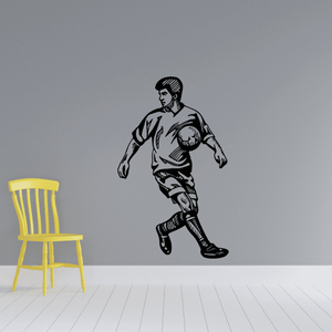 Soccer player vinyl wall decal, black footballer with ball and arms extended