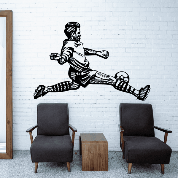 Soccer wall decal of a black-and-white player kicking a soccer ball