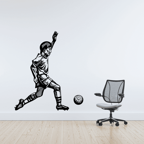 Soccer wall vinyl decal of a kicking player with a soccer ball, black and white