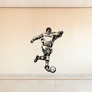 Soccer wall decal of black soccer player kicking a ball