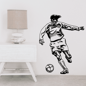 Soccer wall decal showing black cartoon soccer player kicking a ball