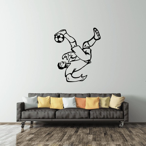 Soccer wall decal of a football player kicking a ball, black vinyl outline.