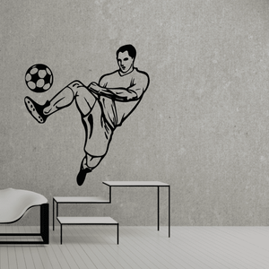 Soccer wall decal of a black soccer player kicking a ball, vinyl sticker