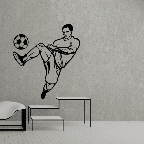 Soccer wall decal of a black soccer player kicking a ball, vinyl sticker