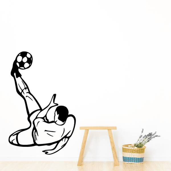 Soccer player wall decal in black vinyl, kicking a soccer ball