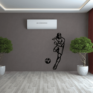 Soccer player vinyl wall decal, black silhouette kicking a soccer ball